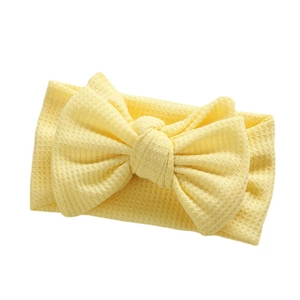 Bright yellow waffle fabric baby headband featuring a large handmade DIY bow design
