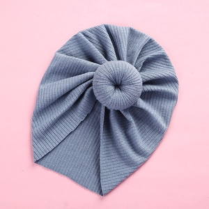 Detail view of the soft ribbed knit fabric and doughnut knot on the blue baby turban