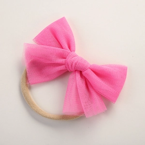 Detailed view of the bright pink mesh bow and high-elastic nylon baby headband material