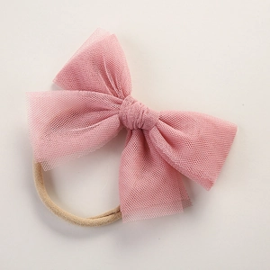 Detailed view of the pink mesh bow and soft nylon headband for babies and infants