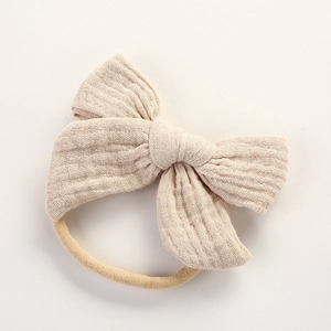 Vue détaillée du bandeau bébé en gaze de coton beige avec bande élastique en nylon doux