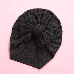 Detail shot of the soft knitted texture and bow on this dark grey baby turban hat