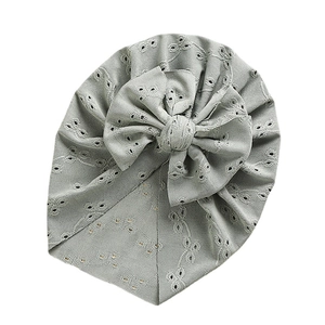 Green lace hollow baby turban hat with elegant eyelet embroidery and a large bow
