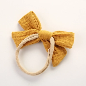 Bandeau bébé en gaze de coton jaune gingembre avec nœud papillon et nylon élastique