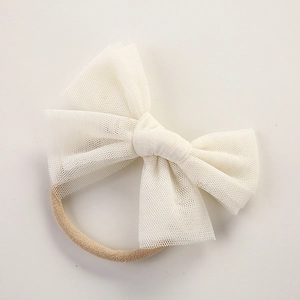 Detail of soft cream mesh bow and seamless nylon headband for newborn babies