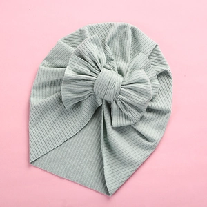 Detail of the soft ribbed knit texture and large bow design on the baby turban headwrap