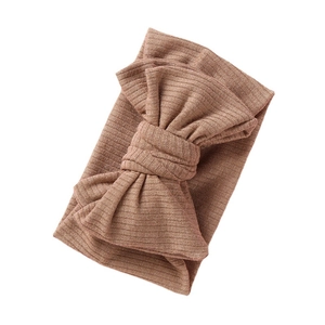 Brown ribbed baby headband with a large double-layered bow on a white background