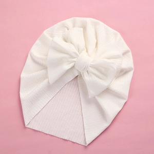 Close-up of soft ribbed texture and large bow on the white baby turban headwrap