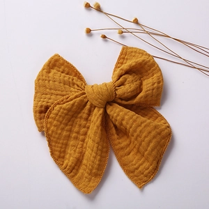 Mustard yellow muslin cotton double bow hair clip for girls in minimalist style