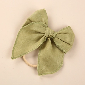 Detailed texture of grass green linen bow headband with durable elastic nylon band