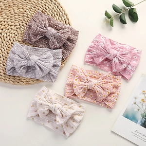 Close-up of five-piece floral print baby nylon headbands with large soft bow details