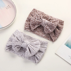 Detail of floral baby nylon headbands with textured fabric and large soft bow knots