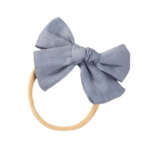 Dusty blue linen bow headband for baby girls with soft elastic nylon band on white background