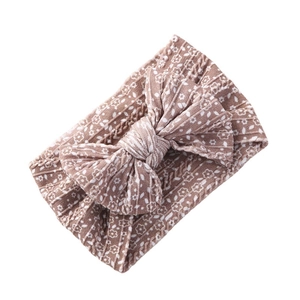 Soft nylon infant headband with large floral bow in dusty rose ribbed knit fabric