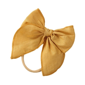 Linen bow headband for baby girls in bright yellow with soft elastic nylon band