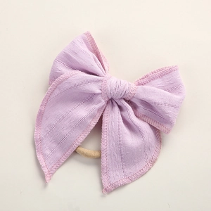 Detailansicht der rosa Jacquard-Baumwollschleife mit weichem Nylon-Stirnband für Babys