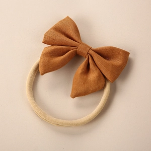 Close-up of caramel linen bow headband with soft seamless high elastic nylon band