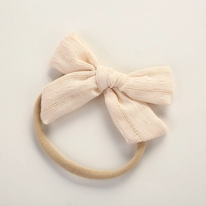 Detail shot of soft pink cotton bow on a high elasticity nylon baby headband