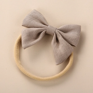 Linen baby headband with a large brown textured bow on high-elastic soft nylon band