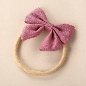 Close-up of pink-purple linen bow headband with soft high-elastic nylon strap for infants