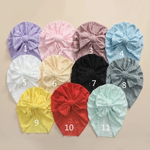 Detail view of 11 color options for hollow embroidered baby hats with large bows