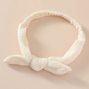 Detail view of cotton muslin baby headband with bunny ears and elastic back texture