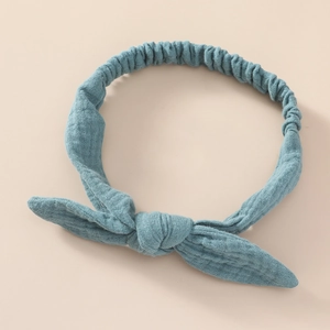 Macro view of blue cotton waffle texture on infant headband with bunny ear knot