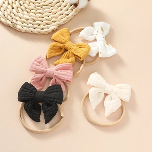 Five-pack of soft cotton bow headbands for newborns in yellow, floral, and solid colors