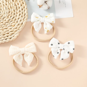 Three-piece set of cotton baby bow headbands featuring floral, waffle, and star patterns