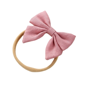 Linen bow headband for babies and toddlers with soft pink fabric on neutral nylon band