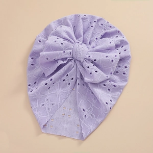 Detail of light purple baby lace turban hat with large bow and hollow eyelet patterns