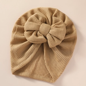 Detailed texture of khaki waffle knit baby turban hat with a large decorative bow