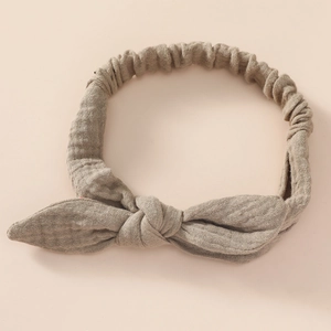 Detail of baby cotton headband showing soft linen texture and elastic bow knot