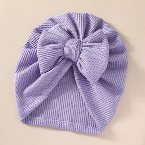 Macro detail of lavender waffle knit fabric and bow on the infant newborn turban hat