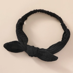 Close-up of black rabbit ear headband showing soft ribbed texture and elastic band