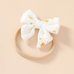 Close-up of soft floral cotton bow with high-elasticity nylon headband for infants