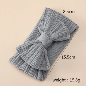 Detail showing 8.5cm width of grey ribbed nylon baby headband with large bow tie