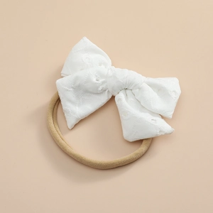 Détail du nœud en dentelle souple et du bandeau élastique en nylon pour bébé