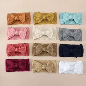 Detailed flat lay of soft jacquard nylon baby headbands in twelve assorted colors