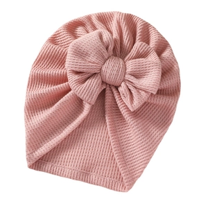 Pink waffle-knit baby beanie with a large double bow decoration for newborns