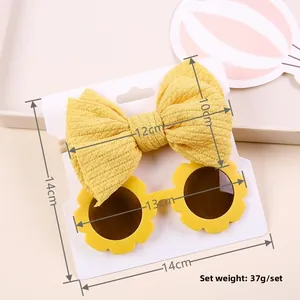 Detail view of sunflower sunglasses and striped waffle bow headband set for babies