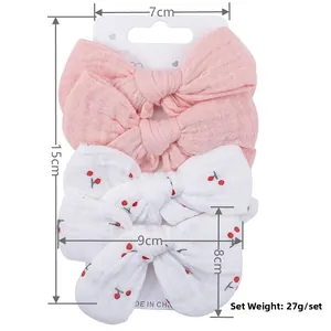 Detailed view of 4-piece baby cotton bow hair clips set with size and weight specs