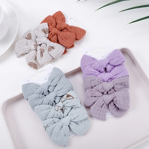 Set of 4 cotton bow hair clips for babies with rainbow prints in a gift display tray