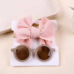 Pink bow headband and vintage round sunglasses set for babies on display card