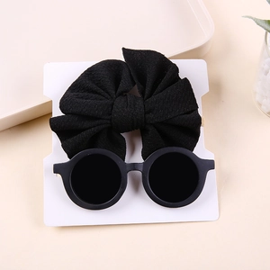 Baby accessories set including a black bow nylon headband and round black sunglasses
