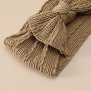Brown jacquard nylon baby headband with large bow and soft ribbed texture for infants