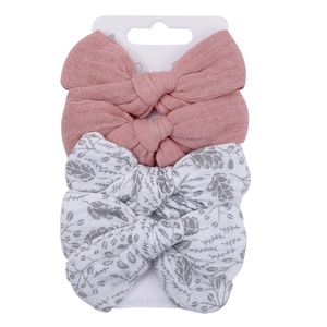 Detail of 4-pack baby cotton bow hair clips with pink and leaf print patterns