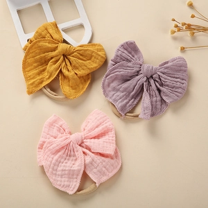 Drei Baby-Stirnbänder mit Baumwollschleifen in Gelb, Lila und Rosa für Kleinkinder