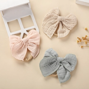 Dreiteiliges Baby-Stirnband-Set aus Baumwoll-Musselin in Apricot, Rosa und Blau