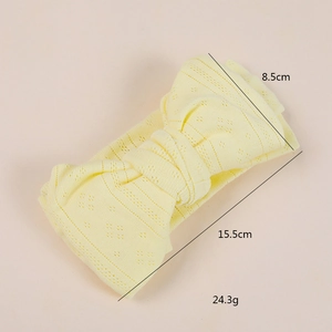 Knitted jacquard bow baby headband in soft light yellow with hollow diamond patterns